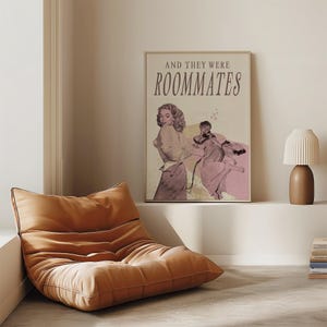 A framed print with two ladies in a romantic pose, with the text 'and they were roommates'.