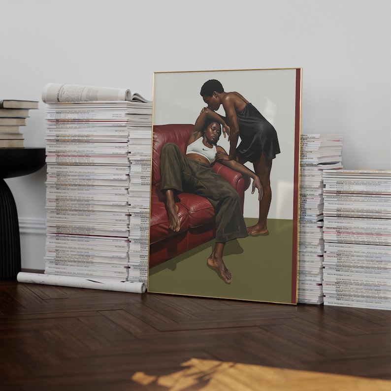 A framed poster with a black, lesbian couple kissing.