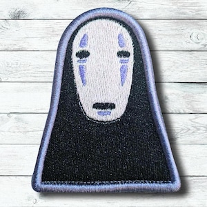 May include: Embroidered patch featuring the character No-Face from the animated film Spirited Away. The patch has a black body and a white face with purple accents. The patch is outlined in a light blue color.