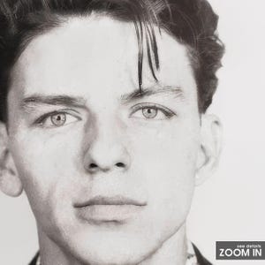 May include: Black and white portrait photograph of a young man with dark hair styled in a side part. He is looking directly at the camera with a serious expression.