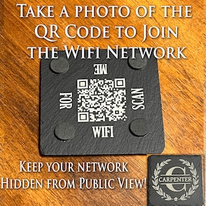 May include: Black slate coaster with a QR code and the text "SCAN ME FOR WIFI". The coaster has four rubber feet on the bottom. A second slate coaster with a wreath and the letter "C" in the centre and the text "CARPENTER" below. The text "TAKE A PHOTO OF THE QR CODE TO JOIN THE WIFI NETWORK" is above the coasters. The text "KEEP YOUR NETWORK HIDDEN FROM PUBLIC VIEW!" is below the coasters.