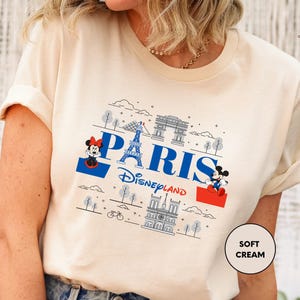 a woman wearing a t - shirt with the word paris on it
