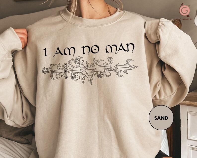 a woman wearing a sweatshirt that says i am no man
