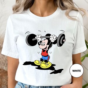 a woman wearing a mickey mouse t - shirt