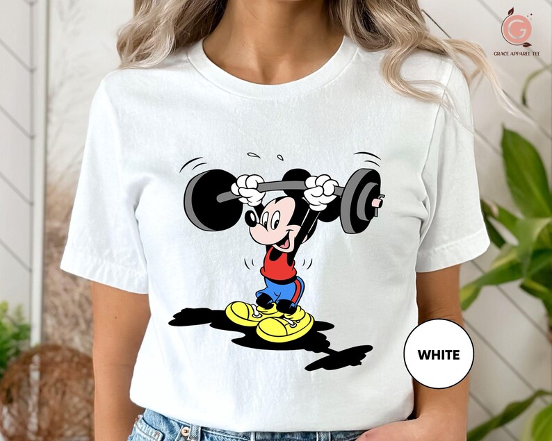 a woman wearing a mickey mouse t - shirt