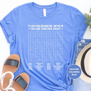 a blue t - shirt that says to anyone behind me are in this line together