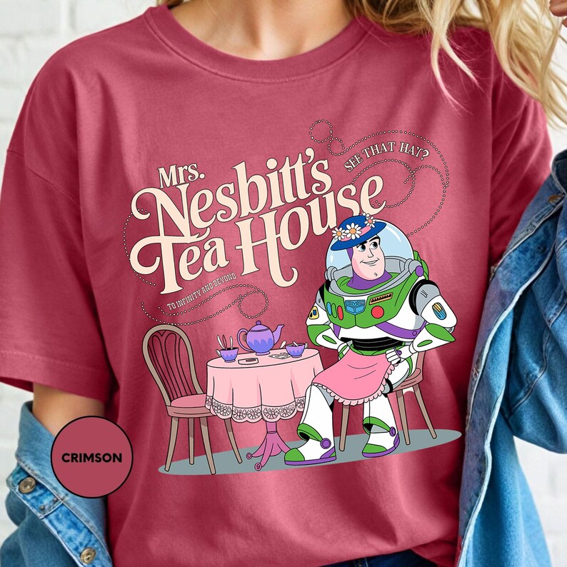 a woman wearing a t - shirt with a cartoon character on it