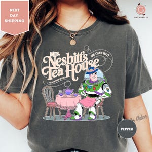 a woman wearing a tshirt with a cartoon character on it