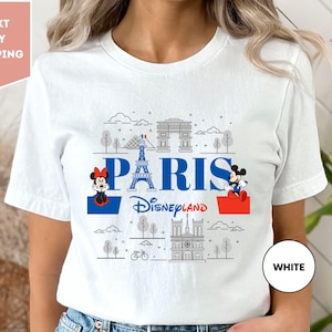 a woman wearing a white t - shirt with the words paris on it