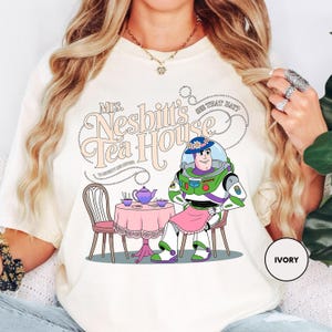 a woman wearing a t - shirt with a cartoon character on it