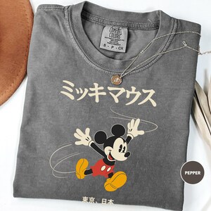 a mickey mouse tshirt with a hat on top of it