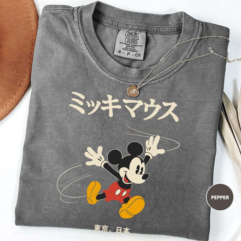 a mickey mouse tshirt with a hat on top of it