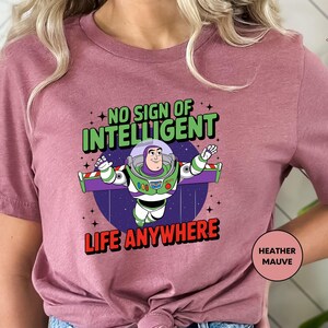 a woman wearing a pink t - shirt that says, no sign of intelligent life