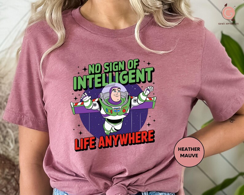 a woman wearing a pink t - shirt that says, no sign of intelligent life