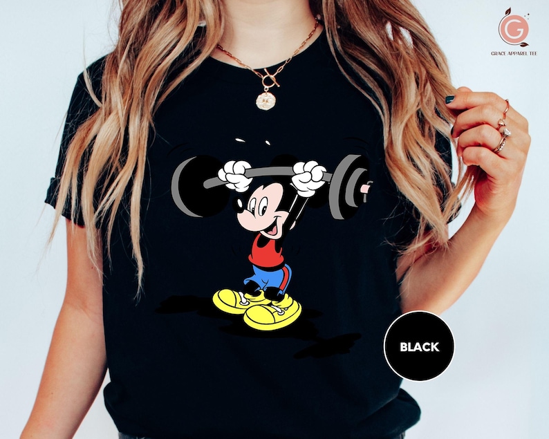 a woman wearing a mickey mouse t - shirt