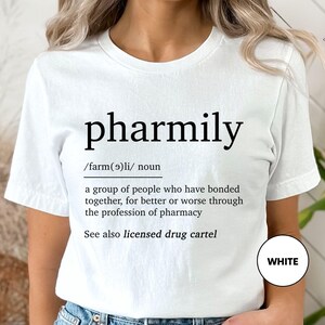 a woman wearing a white t - shirt with the words pharmly printed on