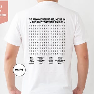 a man wearing a white t - shirt with the words to anyone behind me are