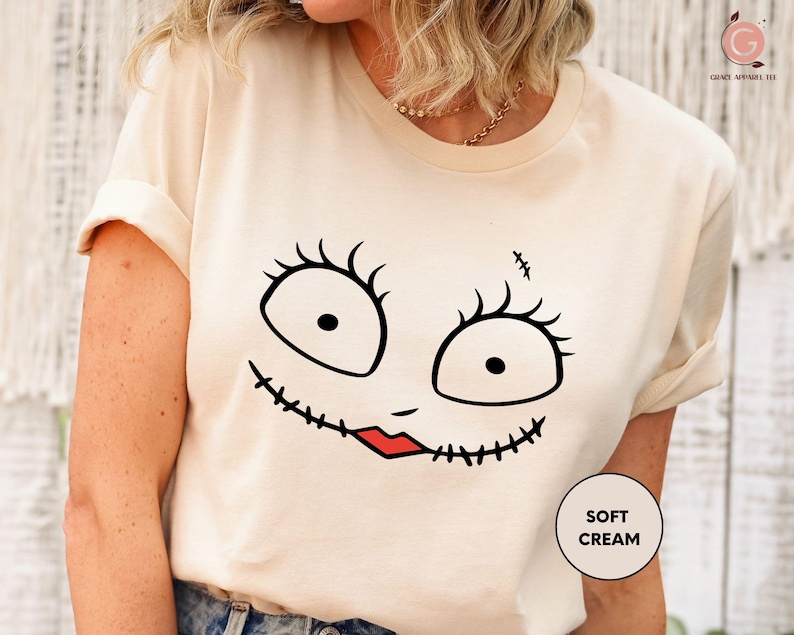 a woman wearing a t - shirt with a face drawn on it