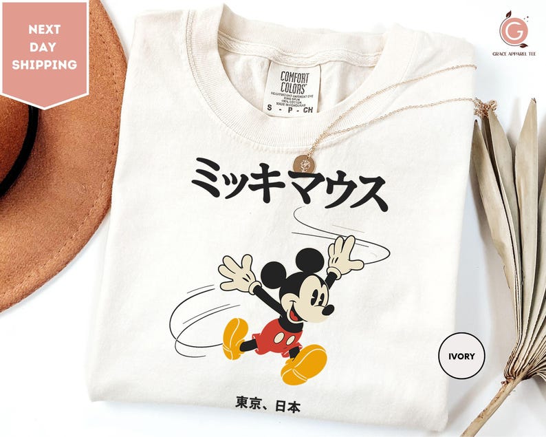 a mickey mouse tshirt with a straw hat next to it