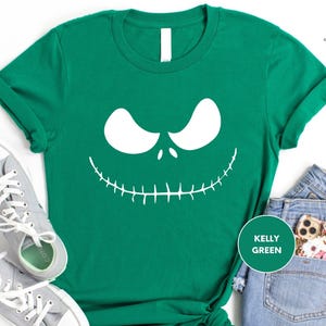 a green shirt with a jack skelling face on it