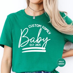 a woman wearing a green t - shirt with a crown on it