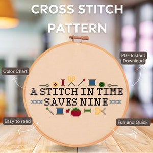 May include: A cross stitch pattern with a beige background and the text "A Stitch in Time Saves Nine" surrounded by colourful cross stitch symbols. The pattern is in a wooden embroidery hoop.