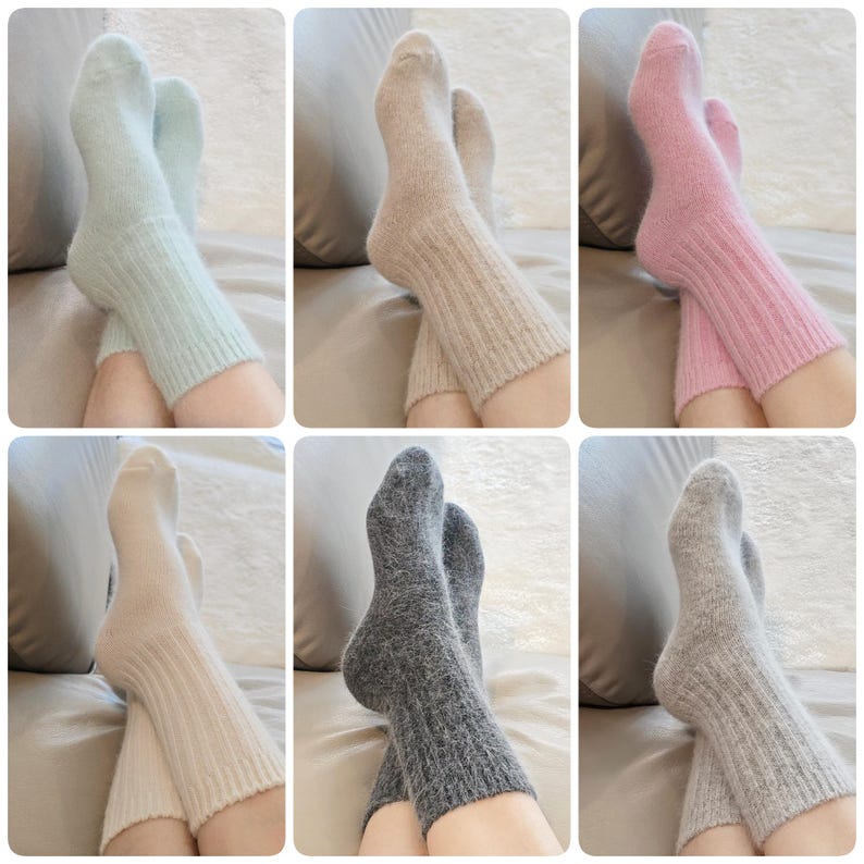 May include: A collection of six pairs of fuzzy, ribbed knit socks shown in various colors including light blue, beige, pink, cream, dark gray, and light gray. Each pair features a soft, textured finish and a mid-calf length design.