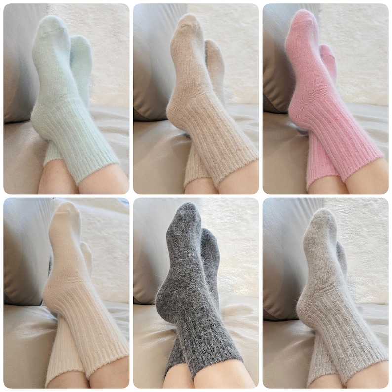 May include: A collection of six pairs of fuzzy, ribbed knit socks shown in various colours including light blue, beige, pink, cream, dark grey, and light grey. Each pair features a soft, textured finish with a ribbed cuff and a classic crew length.
