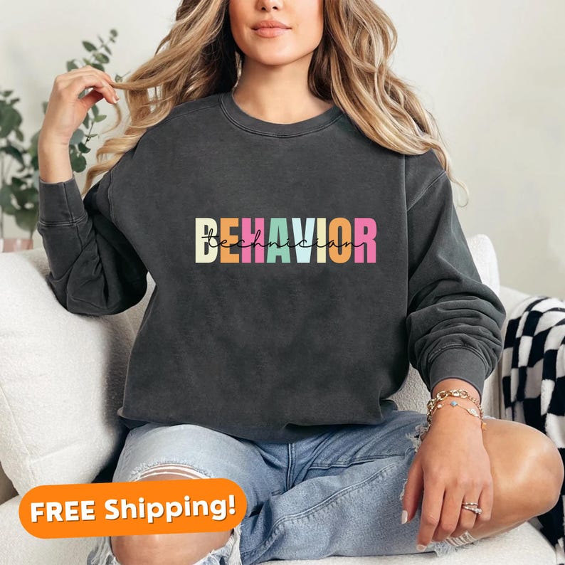 May include: A black sweatshirt with the text "BEHAVIOR technician" in rainbow colors. The sweatshirt is made of a soft, comfortable material and has a relaxed fit.