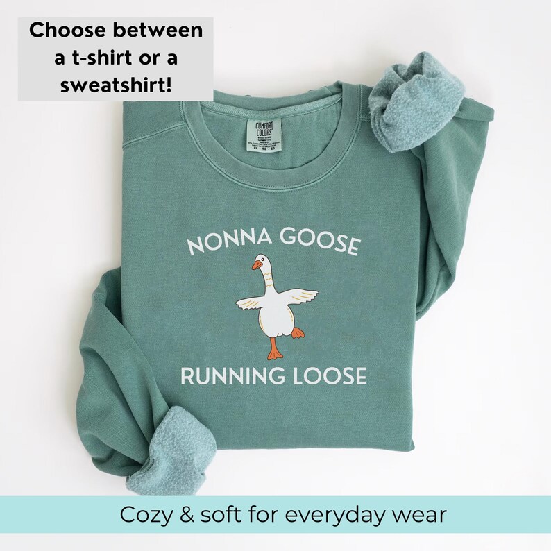 May include: A teal sweatshirt with the text "NONNA GOOSE RUNNING LOOSE" and a cartoon goose illustration. The top text reads "Choose between a t-shirt or a sweatshirt!" and the bottom text reads "Cozy & soft for everyday wear."