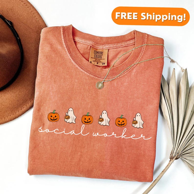 May include: A peach-colored t-shirt with a white graphic of ghosts carrying pumpkins and the text "social worker".