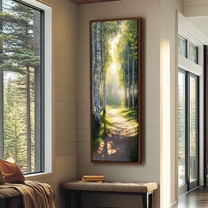 May include: A vertical rectangular wall art piece featuring a sunlit forest path lined with white birch trees. The scene depicts a dirt trail winding through green foliage with bright light filtering through the canopy, framed in a dark wood border.