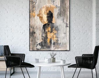 May include: Abstract Buddha art print in a black frame. The artwork features a silhouette of Buddha against a gold circle, with a background of gray, black, and beige brushstrokes. The print is displayed in a modern living room setting.