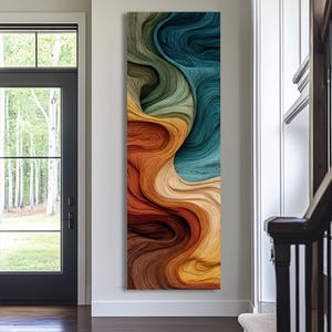 May include: A tall, rectangular wall art piece featuring a fluid, abstract design with layered, swirling textures. The composition displays a gradient of colors transitioning from deep teal and sage green at the top to warm ochre, burnt orange, and dark brown at the bottom.