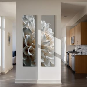 May include: Two vertical rectangular wall art panels featuring a close-up, high-contrast photograph of a white dahlia flower. The petals are layered and curved, displaying soft shadows and highlights that create a sense of depth and texture.