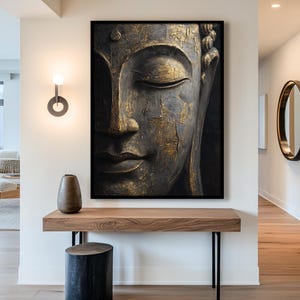 a large, ornate Buddha statue with a golden face and serene expression, mounted on a wall above a wooden console table.