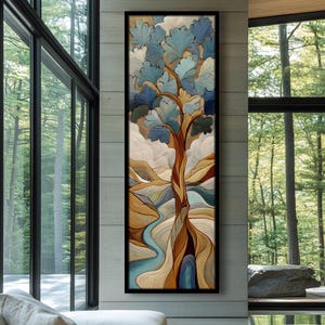 May include: A vertical abstract art piece featuring a tree with blue and white leaves, a brown trunk, and a flowing blue river. The artwork is framed in black and hangs on a concrete wall, with a forest visible through a large window.