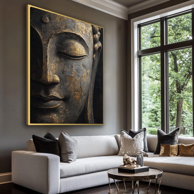 a large, gold-colored Buddha statue displayed on the wall of a modern living room.