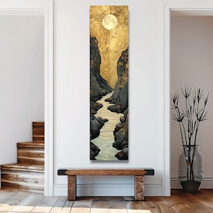 May include: A vertical painting of a river flowing through a canyon with a full moon in the sky. The sky is a golden yellow color and the canyon walls are dark gray. The river is a light blue color.