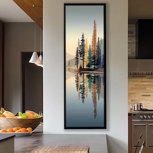 Puede incluir: Impresión artística vertical enmarcada que presenta un paisaje sereno con árboles coloridos reflejados en agua tranquila. La obra de arte muestra un cielo degradado y una escena tranquila, ideal para la decoración del hogar.