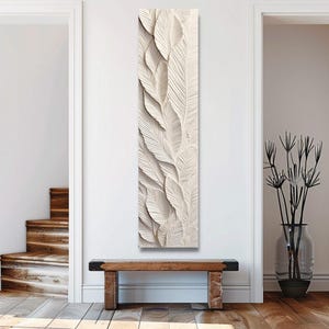 May include: A tall, vertical rectangular wall art piece featuring a relief sculpture of overlapping, textured leaves in a monochromatic off-white color. The design displays intricate vein patterns and layered depth, creating a three-dimensional effect.
