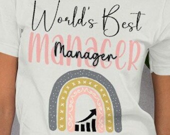 May include: A white short-sleeved t-shirt featuring the black text World's Best Manager, with the word Manager also printed in large pink letters behind it. Below the text is a multi-colored rainbow graphic with a black upward-trending bar graph.