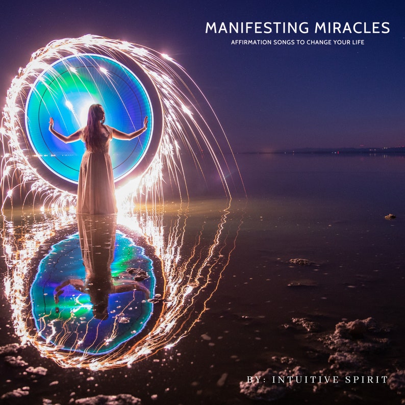 May include: A woman stands in a body of water with her arms outstretched, creating a circle of light with sparklers. The circle of light is reflected in the water. The text "MANIFESTING MIRACLES" and "AFFIRMATION SONGS TO CHANGE YOUR LIFE" is at the top of the image. The text "BY: INTUITIVE SPIRIT" is at the bottom of the image.