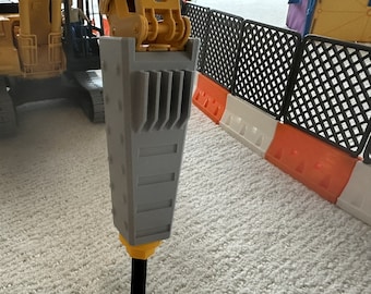 May include: A yellow toy excavator with a grey jackhammer attachment. The excavator is on a white carpet.