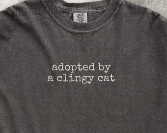 Adopted By A Clingy Cat Shirt Funny Cat Humor  Cat Mom Shirt Cat Dad Tee Gift For Cat Owners I Love My Cat Four Legged Word Velcro Cat Gift