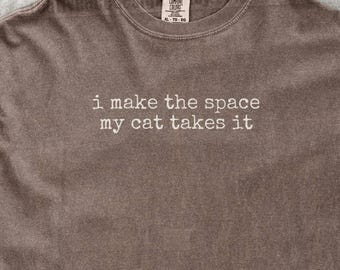 I Make The Space My Cat Takes It Shirt Funny Cat Humor Shirt Cat Mom Shirt Cat Dad Tee Gift For Cat Owners Four Legged Word