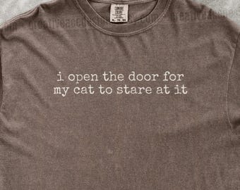 I Open The Door For My Cat To Stare At It Shirt Funny Cat Humor Shirt Cat Mom Shirt Cat Dad Tee Gift For Cat Owners Four Legged Word