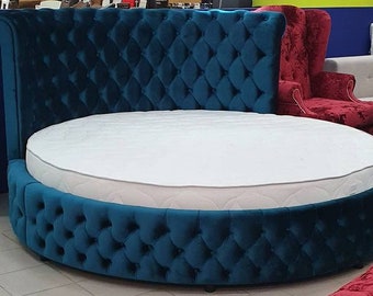 May include: A round bed with a teal velvet headboard and matching base. The headboard has a tufted design and the base has a diamond pattern.