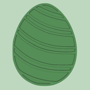 Peut inclure: Un œuf de Pâques vert avec un motif rayé.