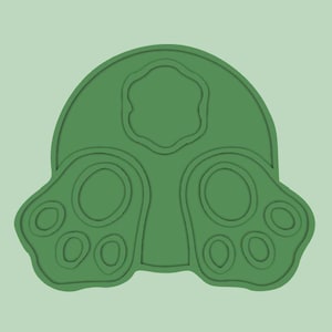 Peut inclure: Emporte-pièce en plastique vert en forme de lapin avec une queue ronde et deux empreintes de pattes.